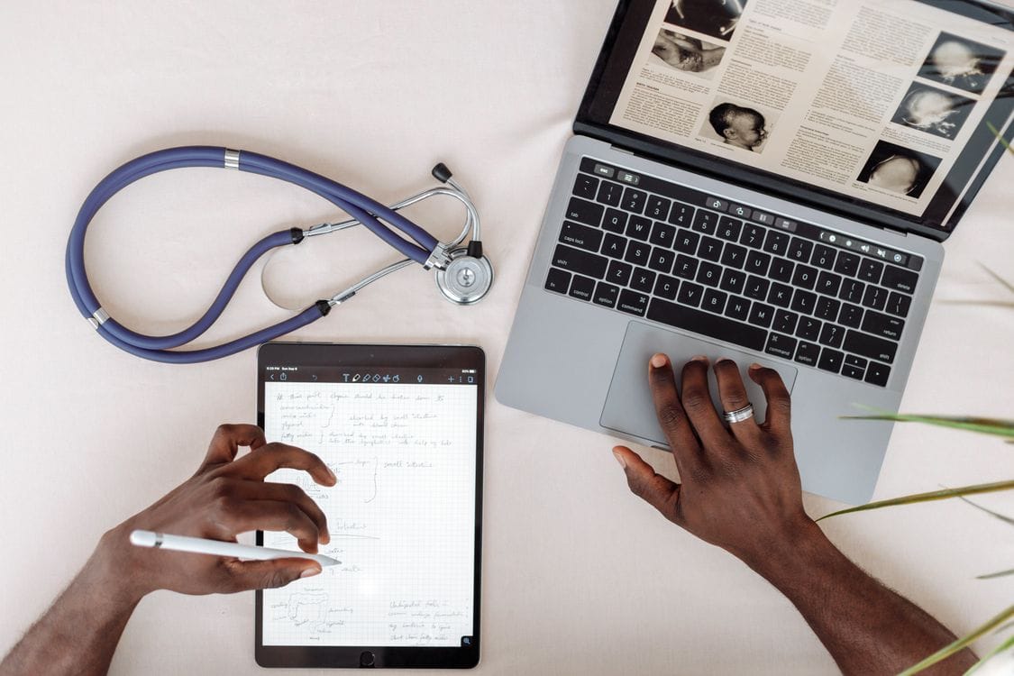 Healthcare professional reviewing medical information on a laptop