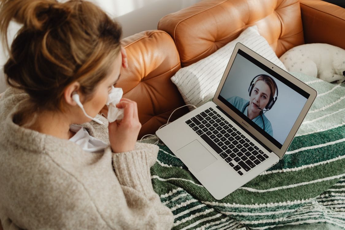Woman researching health information on a laptop at home